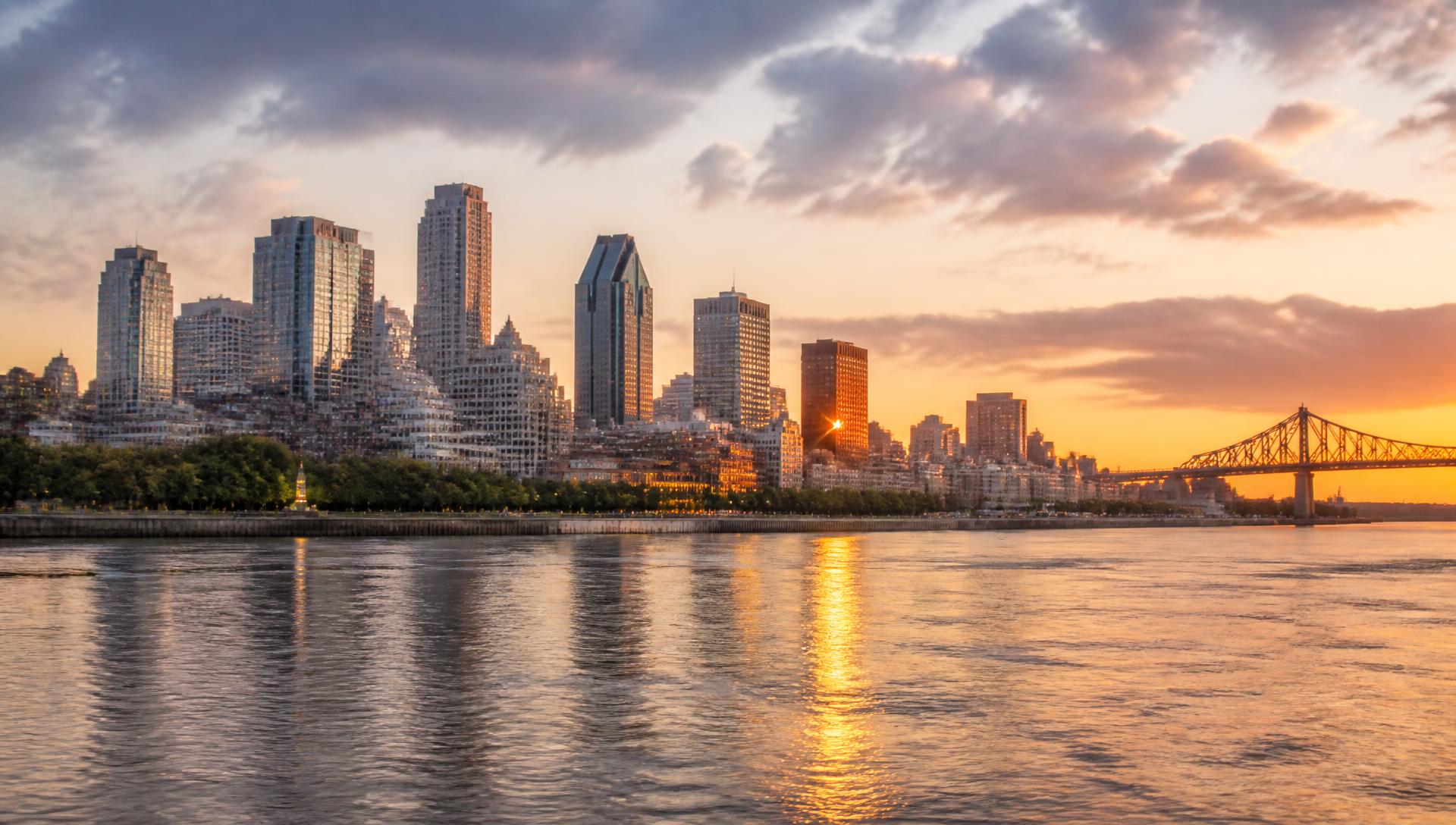 The Montreal skyline at sunset across the St Lawrence River